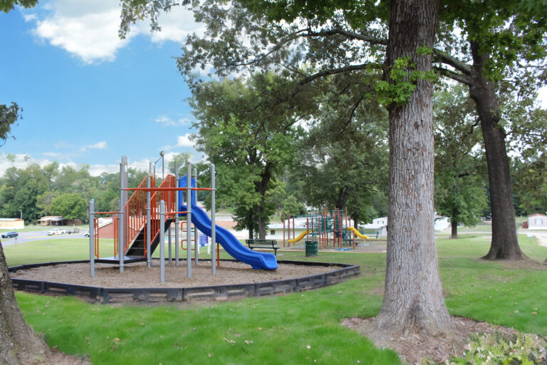 community playground with trees around it