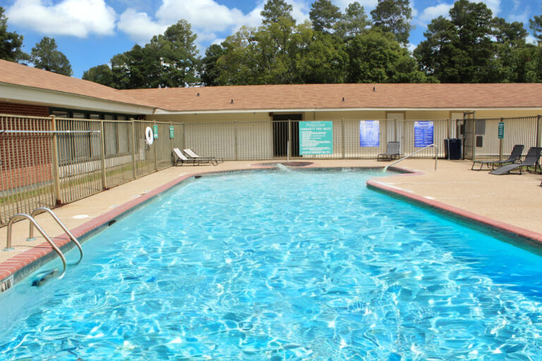 a swimming pool with a fence and a building